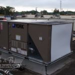 A york air conditioner is sitting on top of a roof.