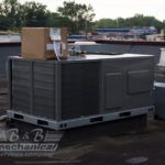 A large air conditioner is sitting on top of a roof.