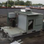 A large machine is sitting on top of a roof.