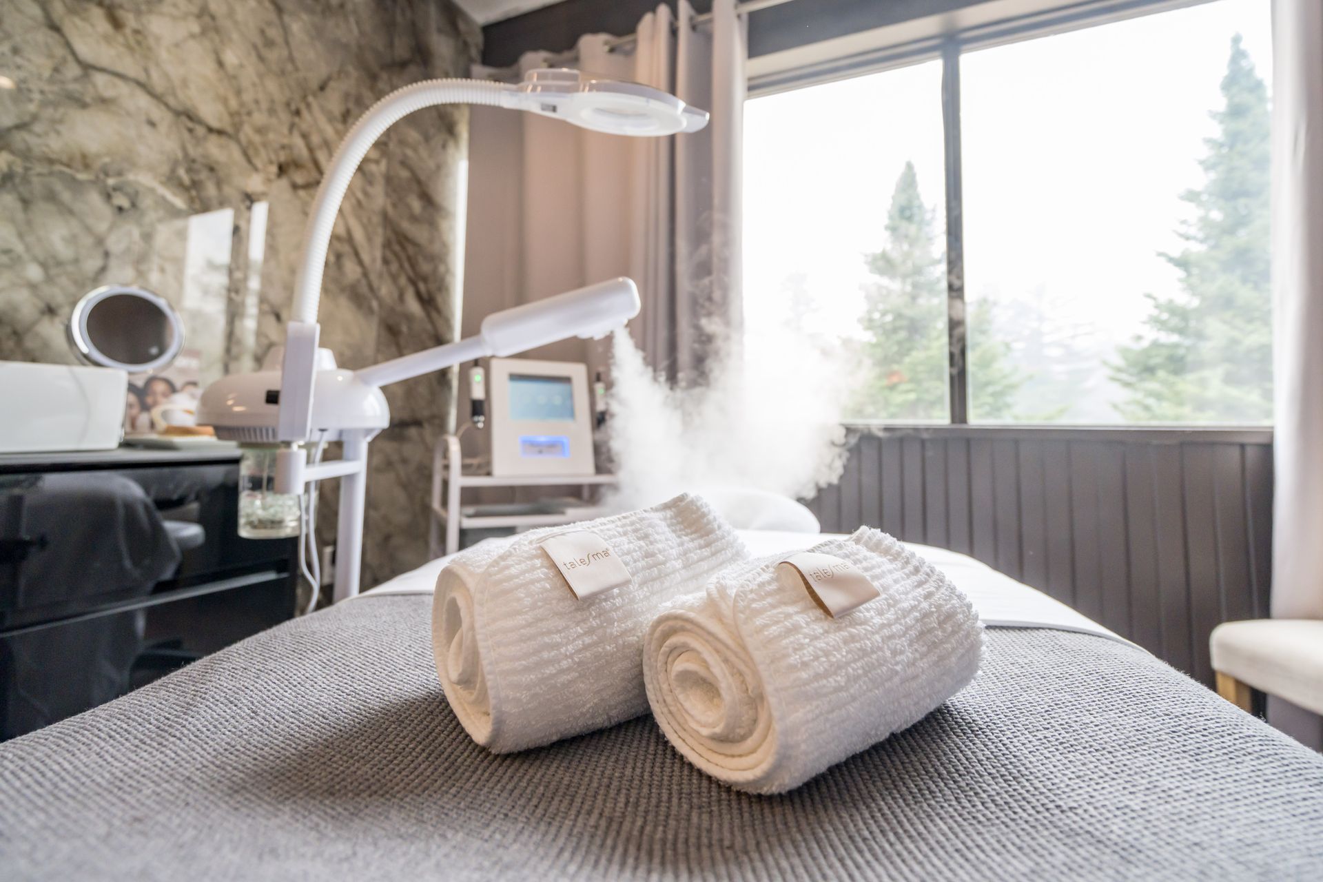 Two towels are rolled up on a table in a beauty salon.