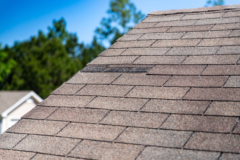A house with a roof that is peeling off