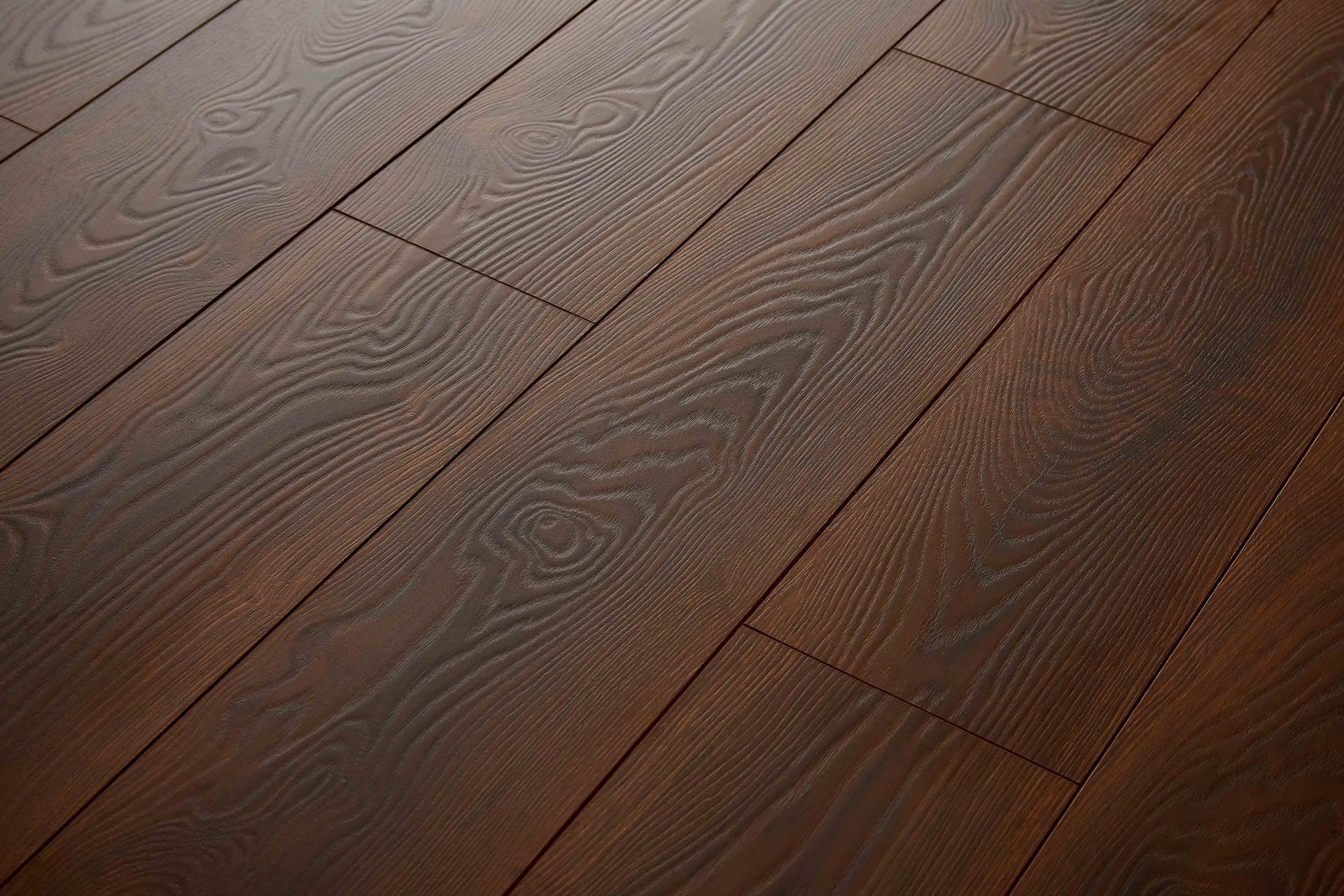 Dark brown wood flooring with visible grain and subtle shading.