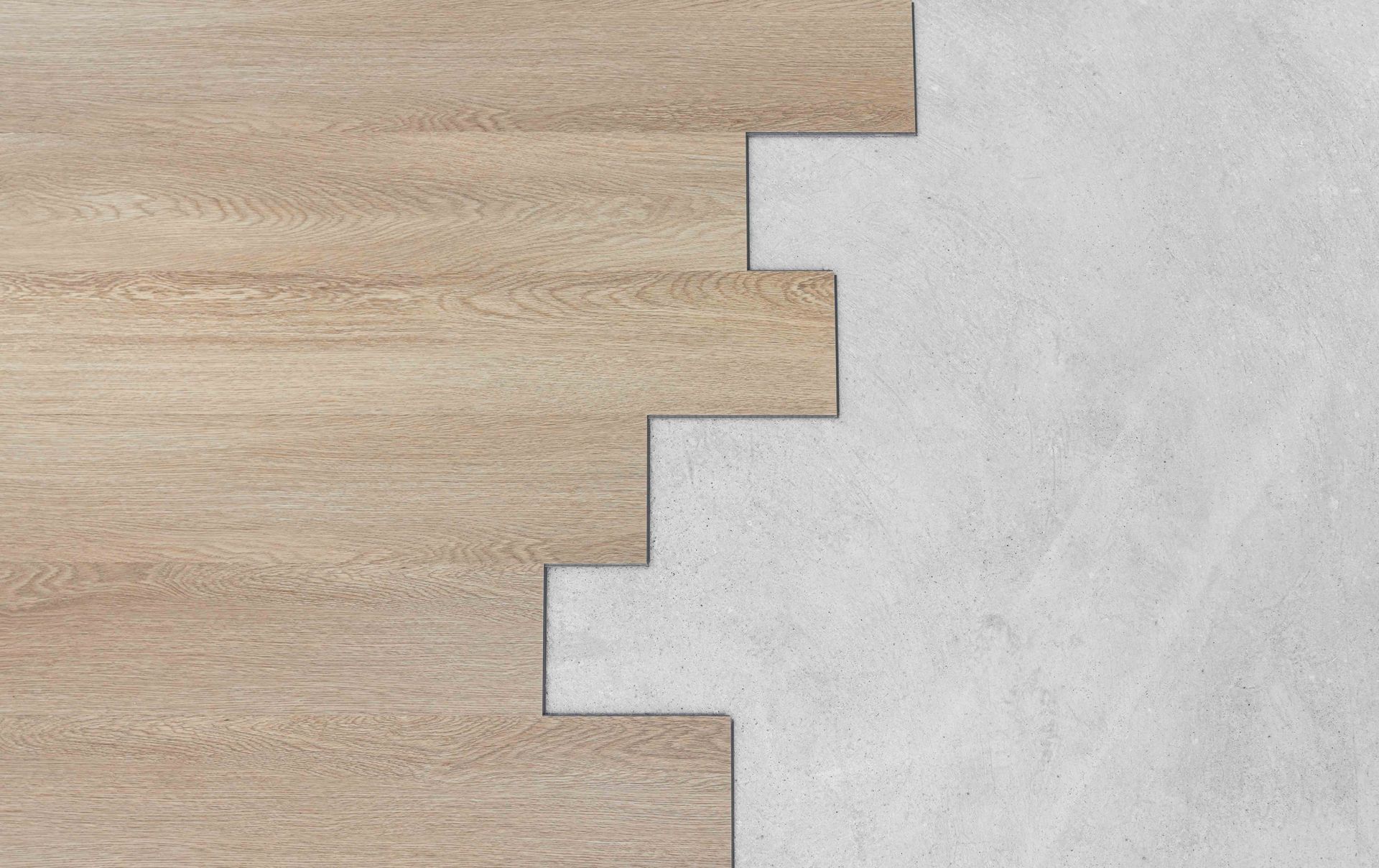 Wooden planks interlock with a concrete surface, showing construction or design.