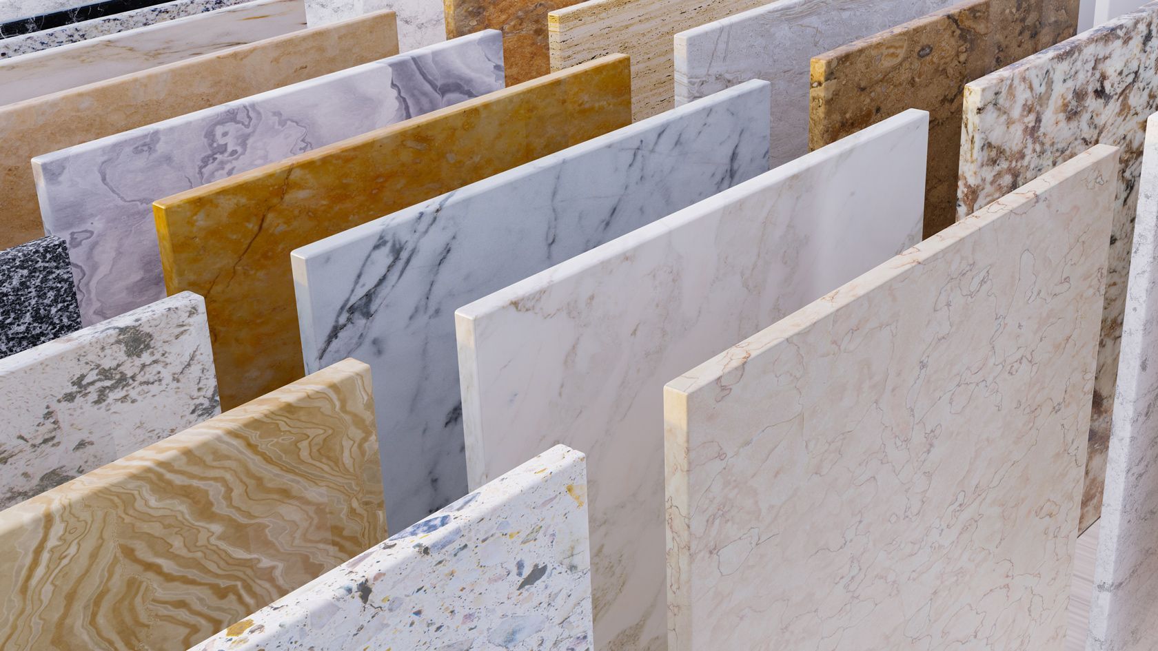 Various stone slabs in different colors and patterns, arranged upright.