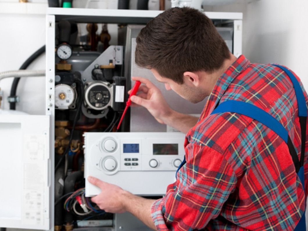 technician installing thermostat