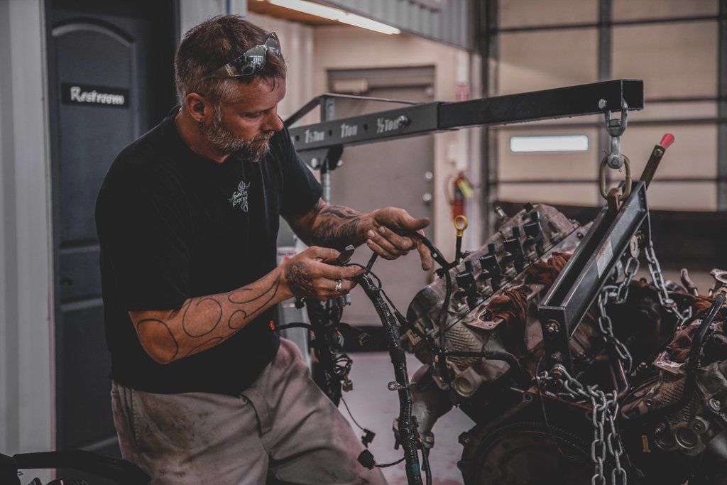 mechanic performing maintenance on vehicle engine