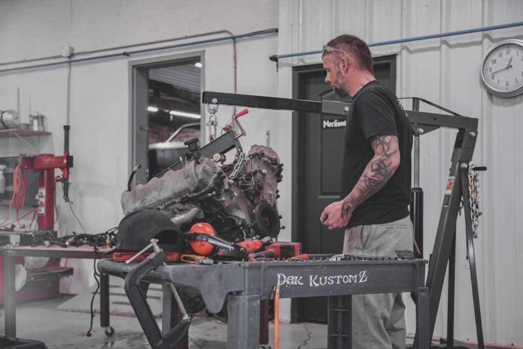 mechanic inspecting vehicle engine