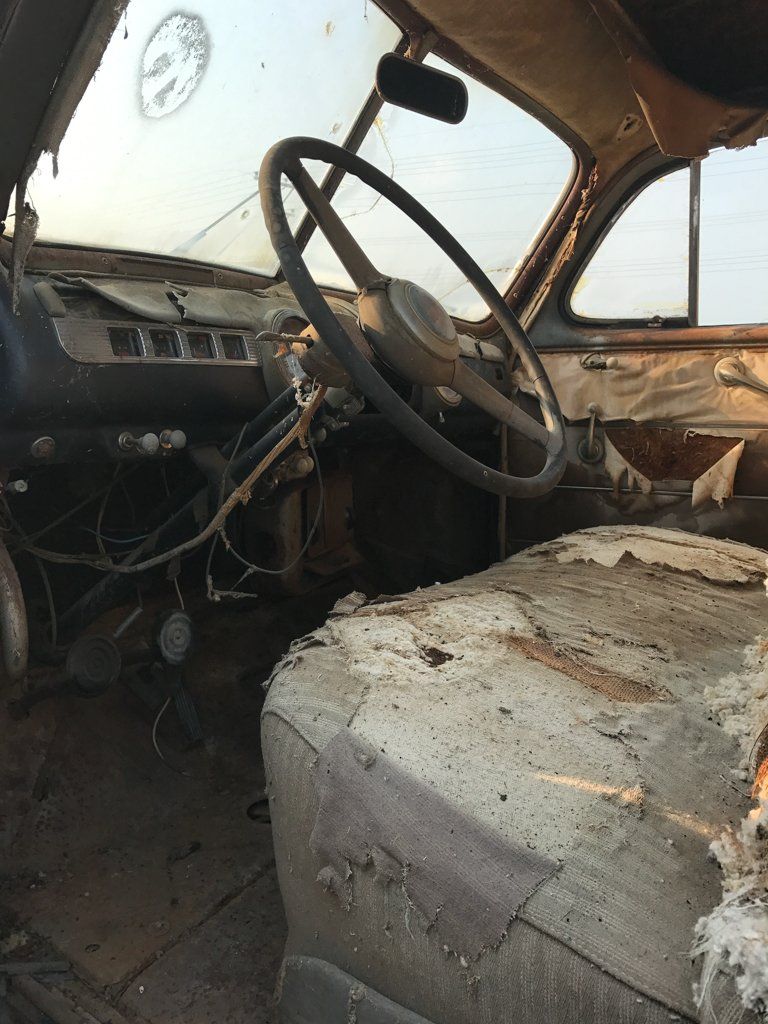 drivers seat with torn seat covers and exposed wires