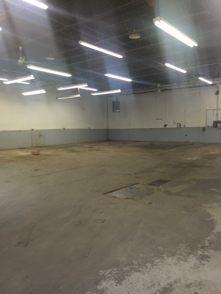 empty building room with lit fluorescent lighting