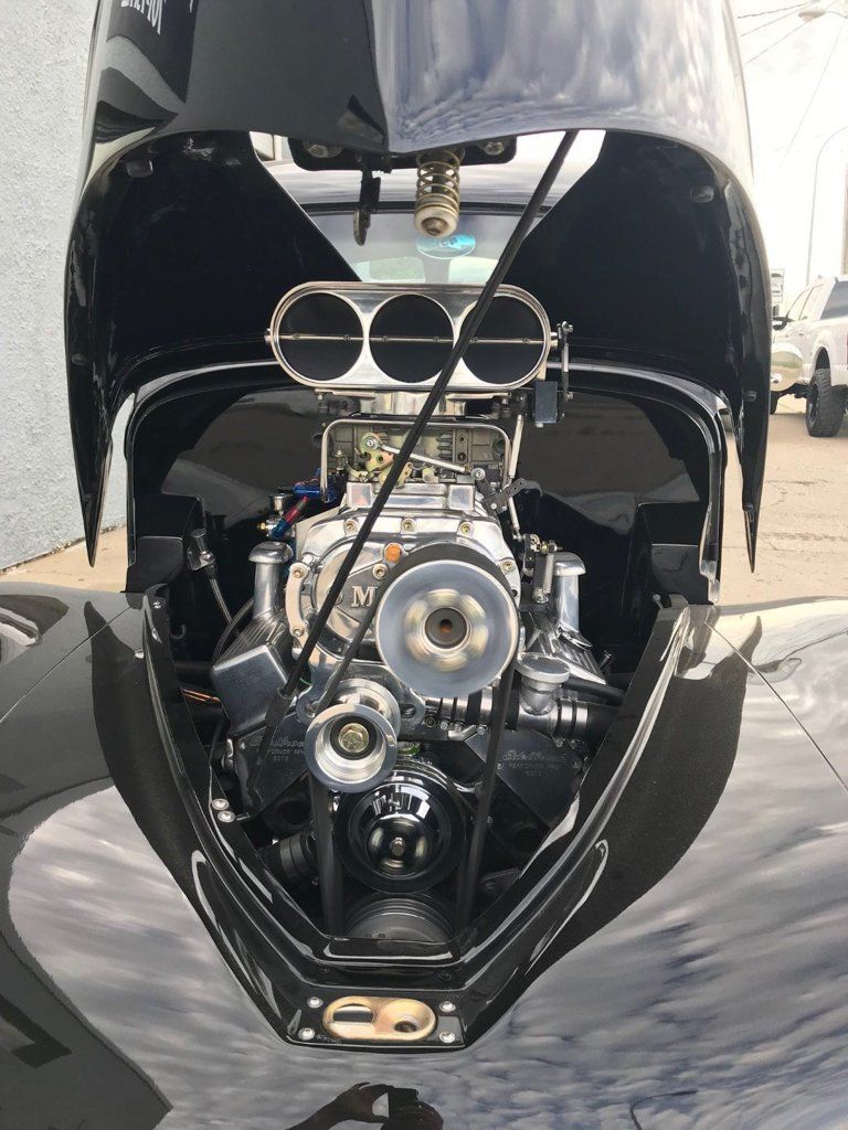 engine in motion on top of willys coupe