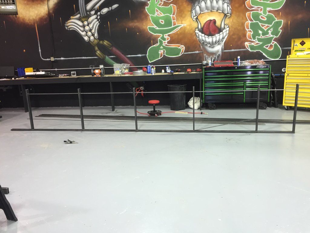 custom railing frame in front of dakota kustomz graffiti wall art