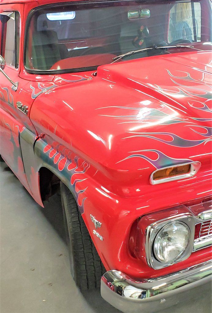 front view of headlight of 1962 customized red truck with grey flames