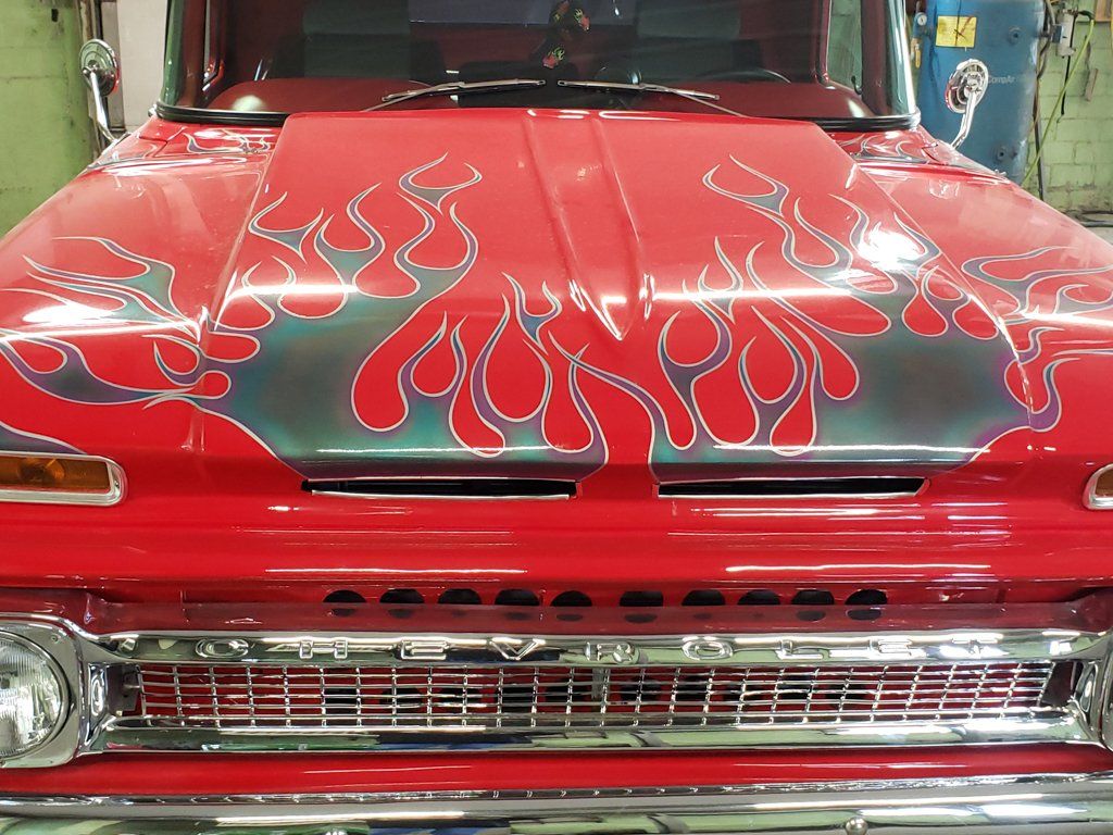 front view of 1962 customized red truck with grey flames hood and grill
