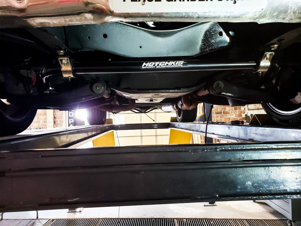 underside view of black 1968 RJ C10 in service bay