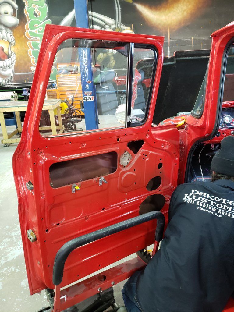 view of door with panel removed of red customized truck