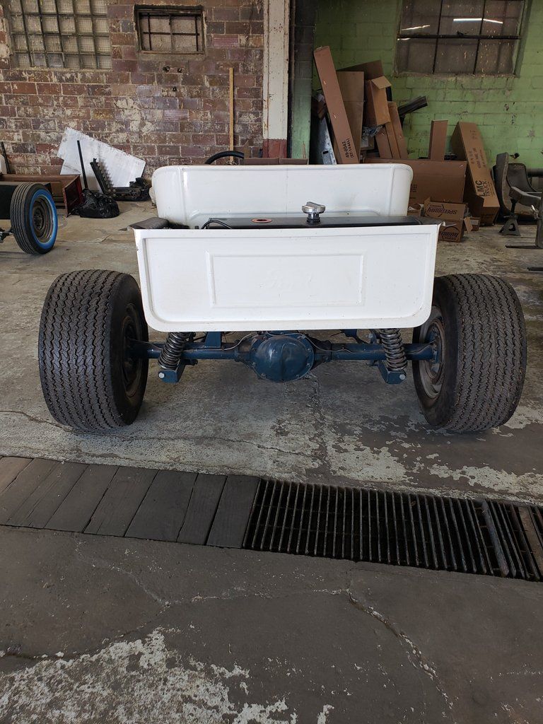 rear view of customized white hot rod inside garage