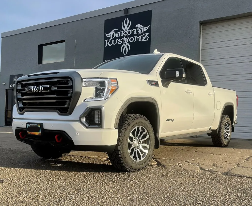 custom 2021 GMC AT4 pickup truck in front of dakota kustomz garage