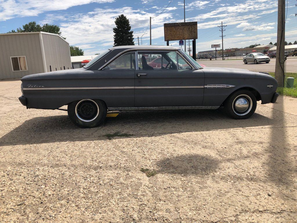 side view of grey muscle car outdoors