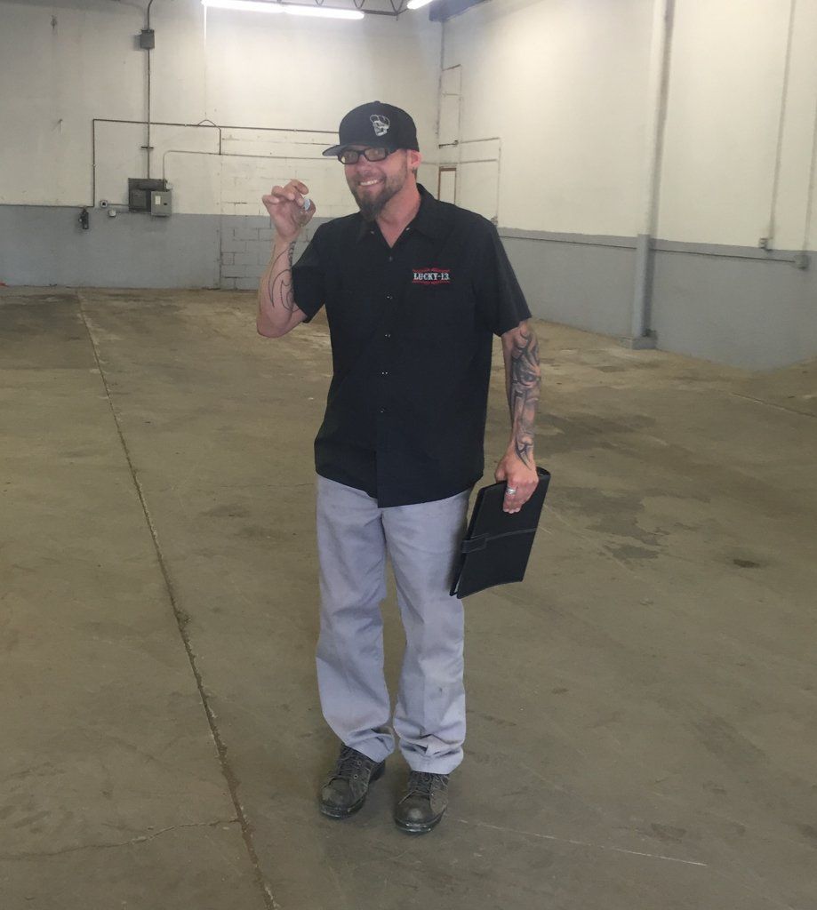 owner travis feist posing with keys