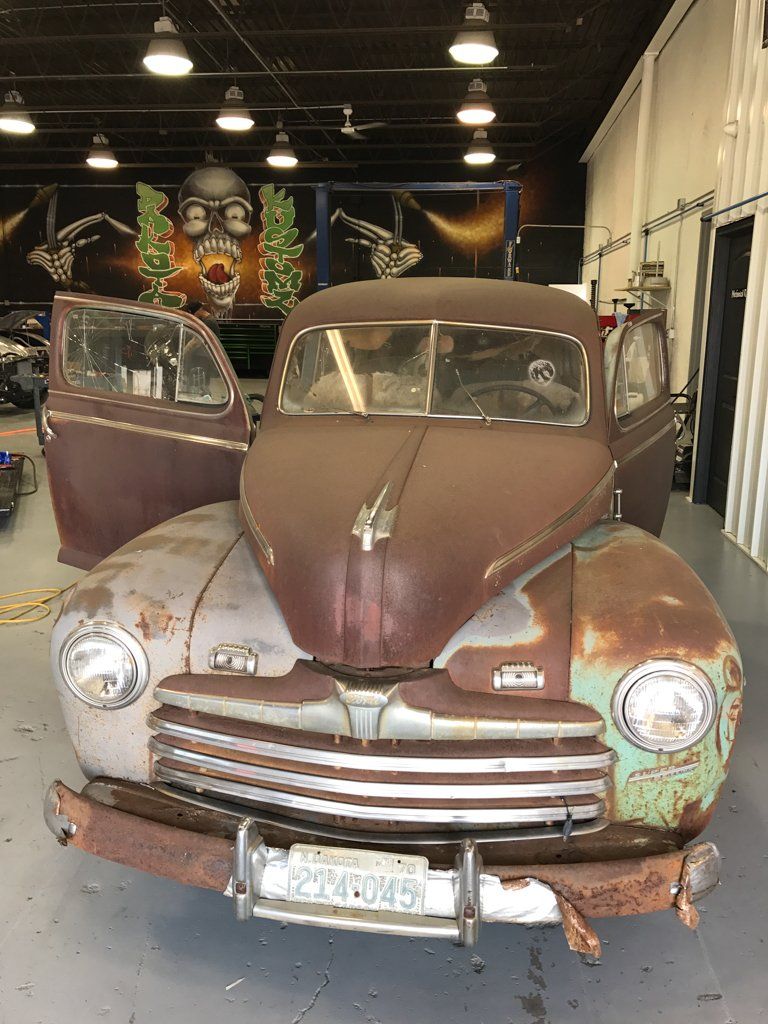rusted car fender and browned hood