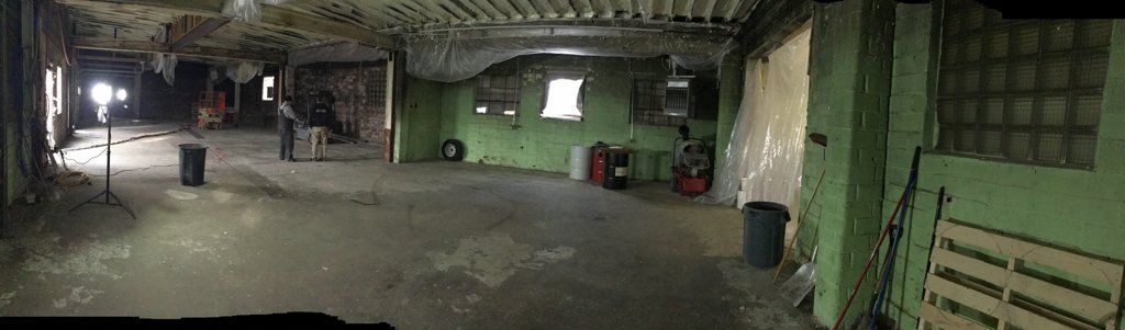 empty room with tools and barrels against the wall