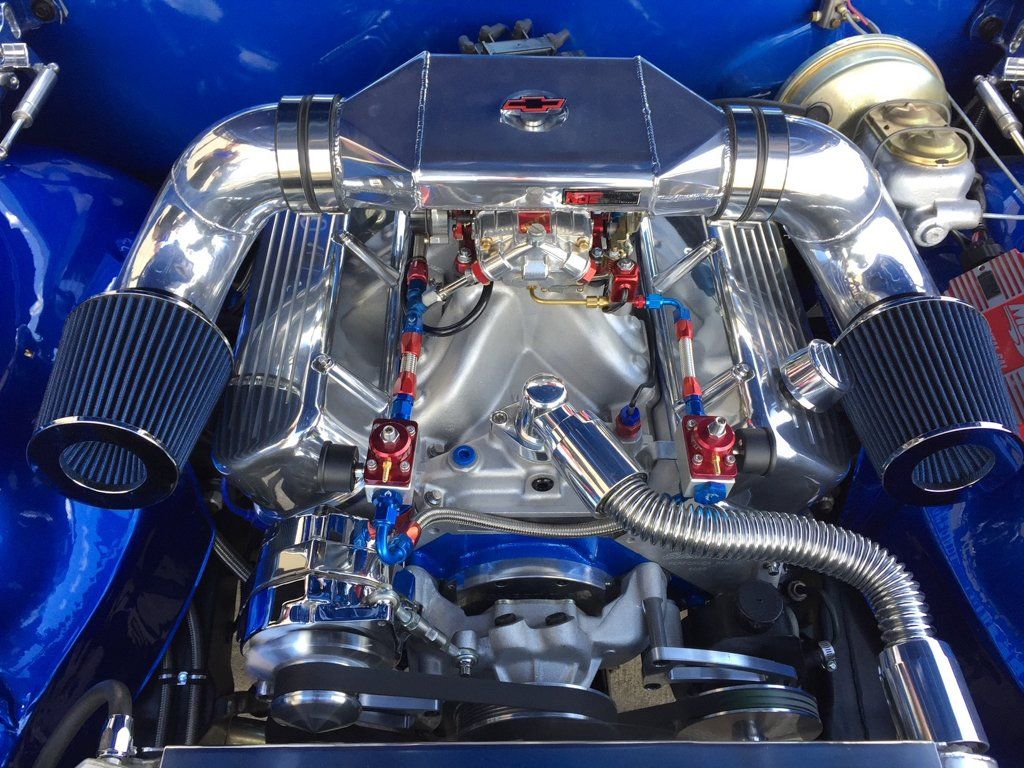 close up of car engine in car with wires and pipes