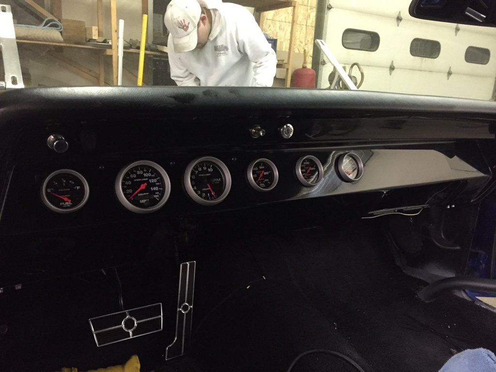 interior view of car dashboard and pedals with no steering wheel