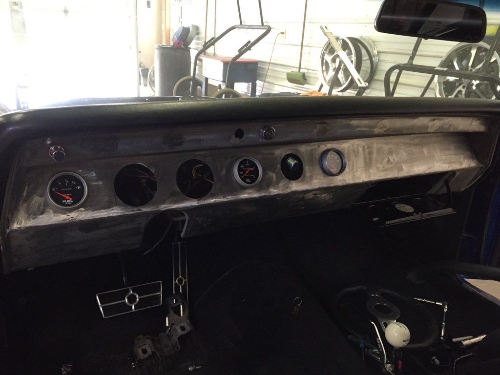 car dashboard with steering wheel removed and readings missing