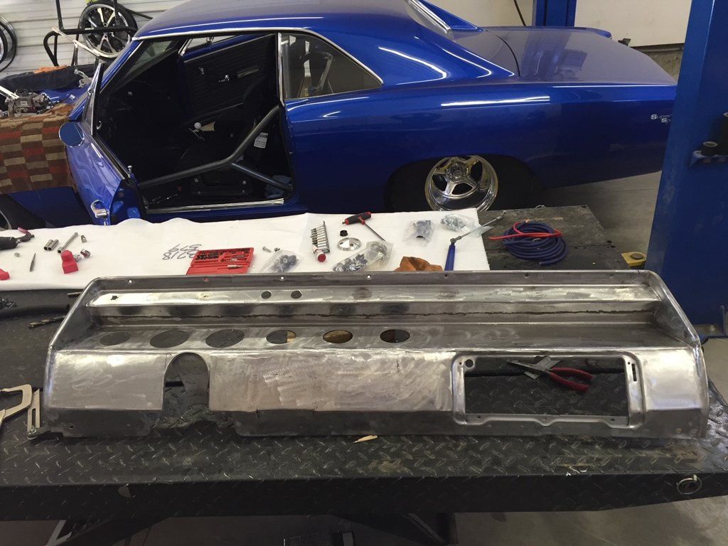 side view of car with car part on workbench