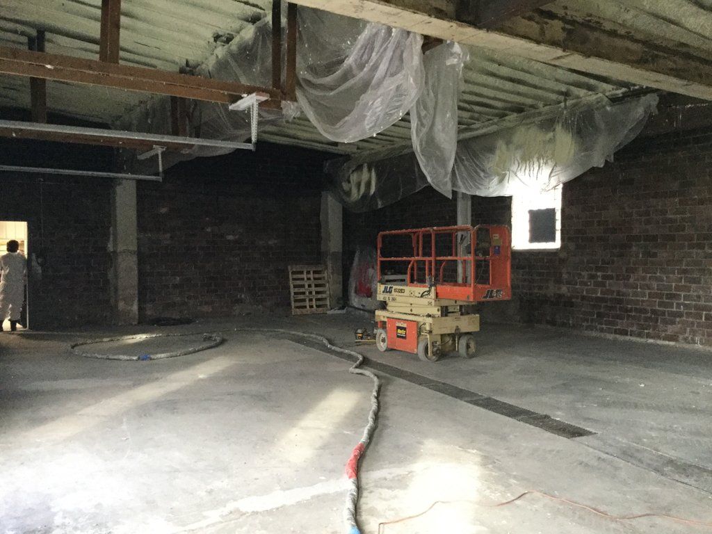 building space under construction with scissor lift
