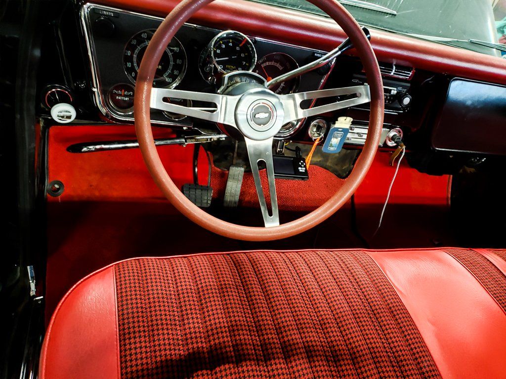 close up of customized driving steering wheel and red custom interior