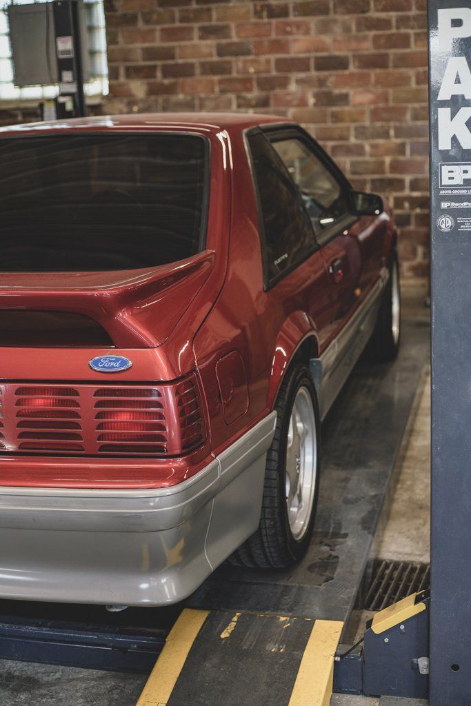 rear passenger side view of car on service bay