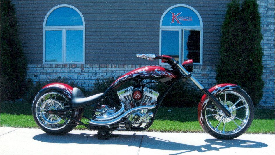 side view of customized chopper in front of kustomz inc office