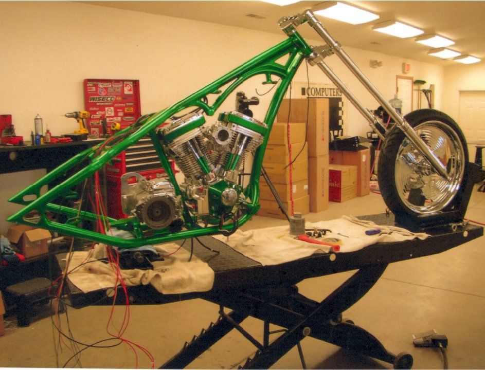 alternate side view of customized green chopper on workbench