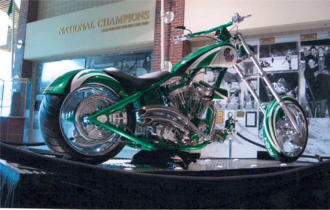 side view of customized green chopper on sidewalk
