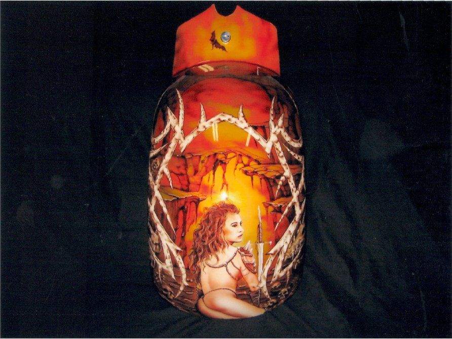 close up of fender with custom orange and red gothic design with woman