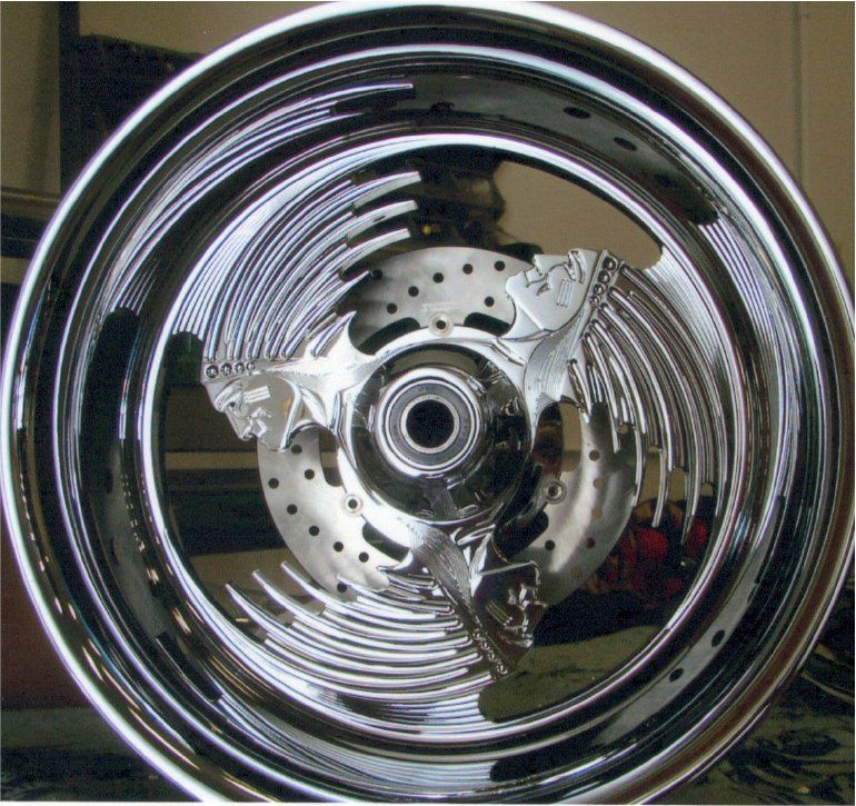 close up of native american designed rims for customized green chopper