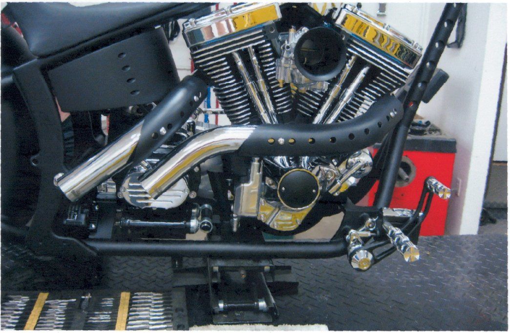 close up of chopper engine and custom black painted parts