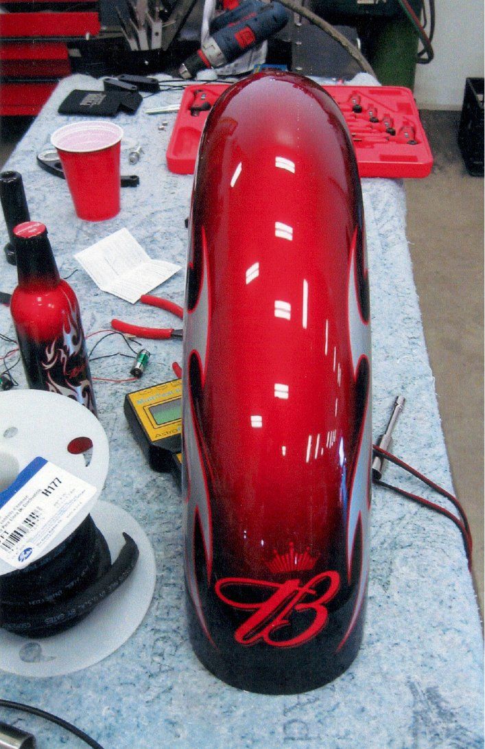 painted red fender on workbench