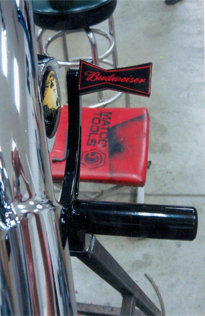 close up of budweiser kick stand on bike with matco tools mat in background floor
