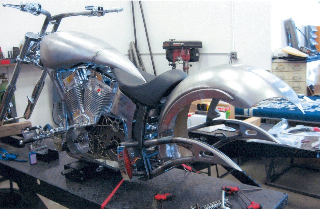 motorcycle on workbench with wheels removed