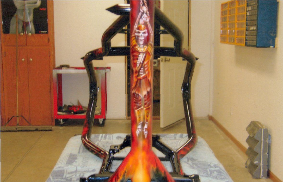 custom art of skeleton on red customized chopper part