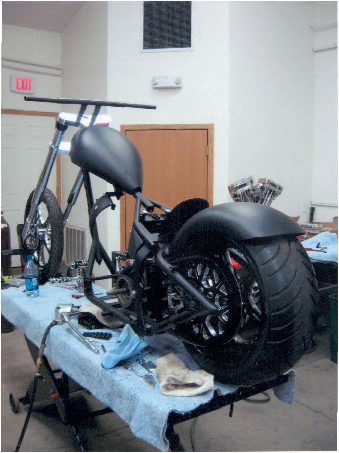 side rear view of customized chopper without engine