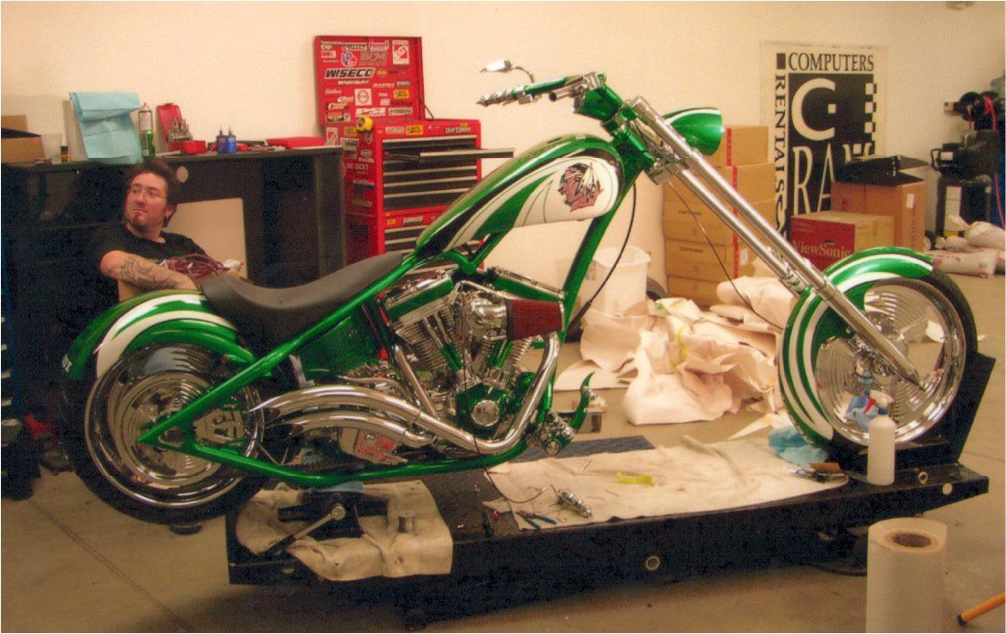 side view of customized green chopper with fuel tank cover added