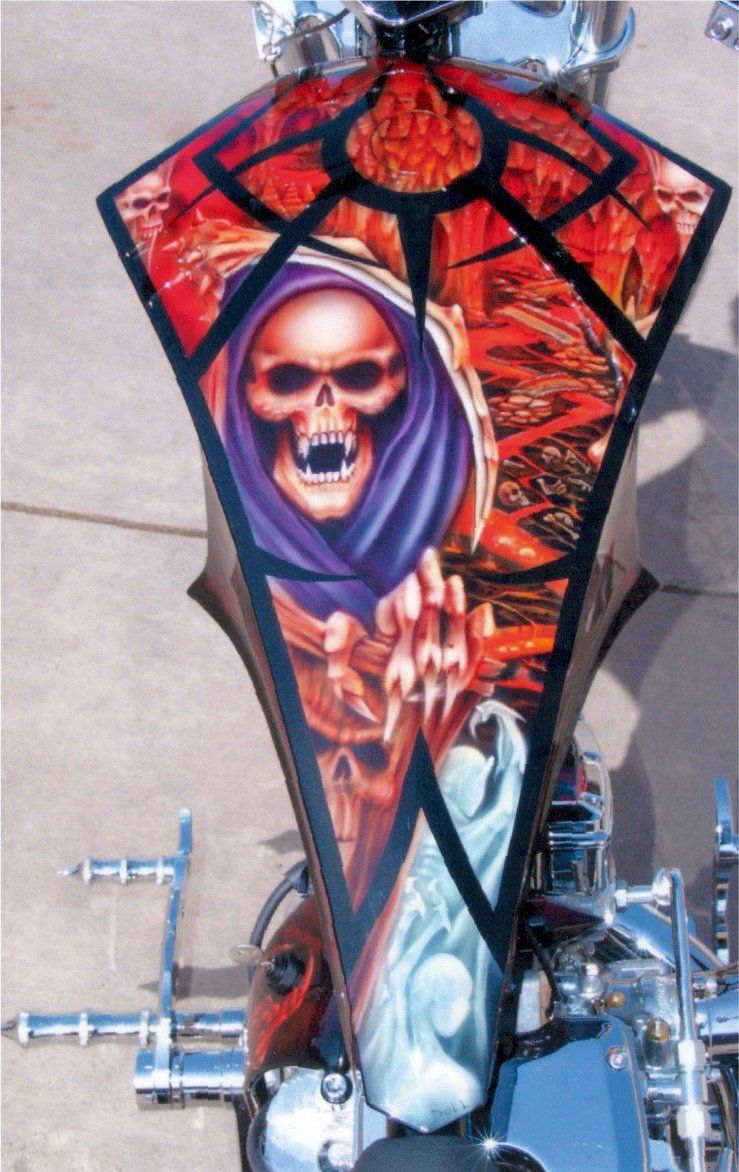 top view of customized gothic style red and orange skull design on fuel tank cover