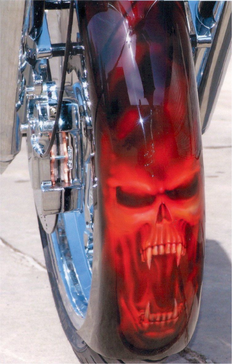 custom art of skull with mouth open on fender of chopper