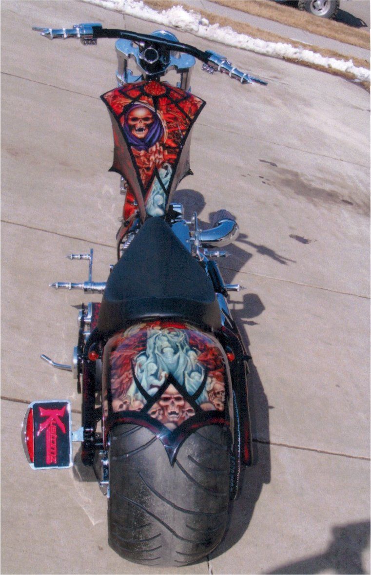 full rear view of customized red and chrome chopper