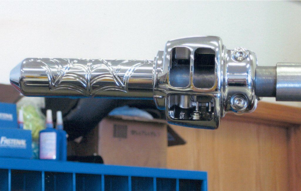 close up of spider web handle bars of motorcycle