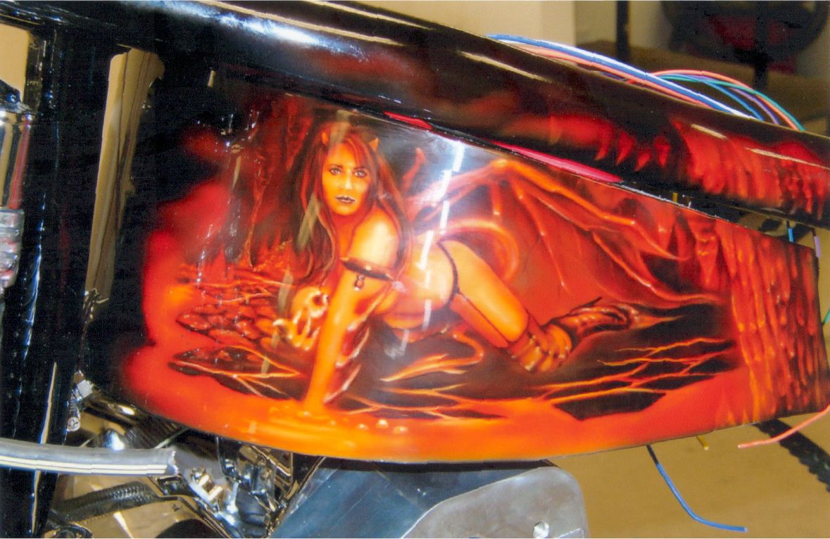 close up of custom orange and red art of devil girl holding skull crawling