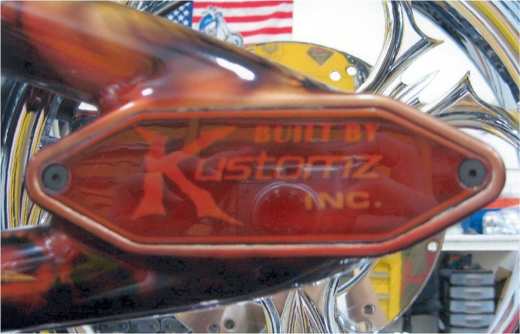 custom orange and red built by kustomz inc logo on chopper